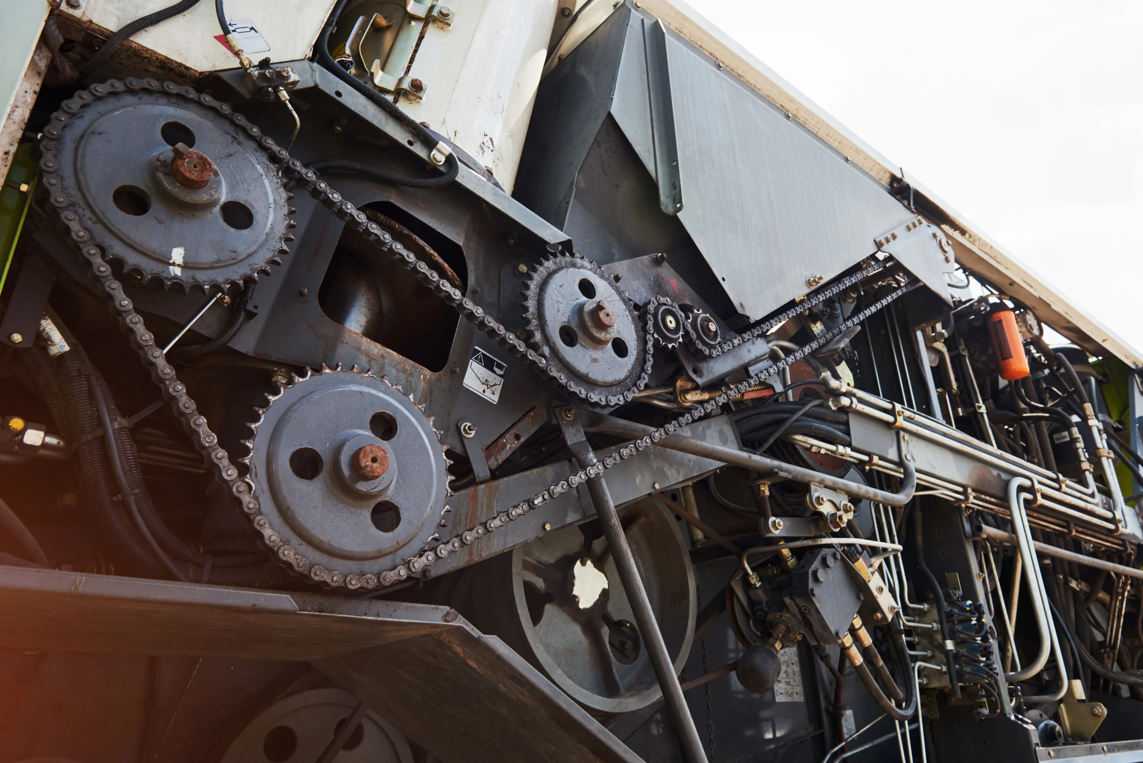 Heavy machinery and harvester parts awaiting maintenance in industrial plant